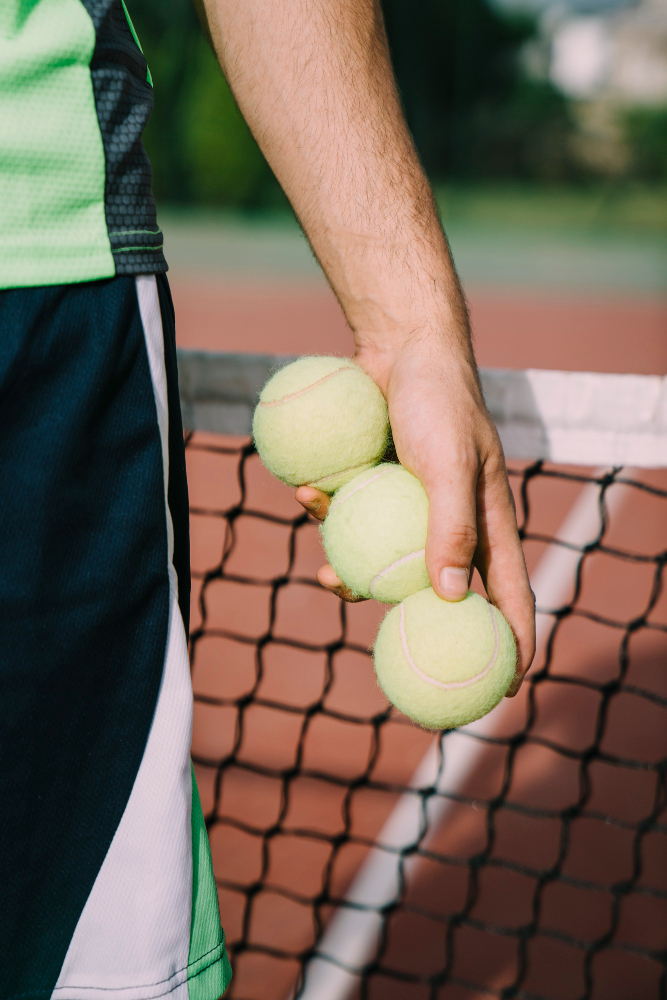 tennis-player-holding-three-balls.jpg